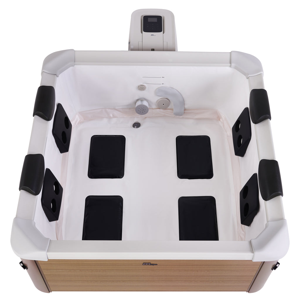 Top down view of empty portable square framed hot tub jacuzzi with a woodlike exterior, an OLED touch screen, black neck rests and black hydromassage jets.